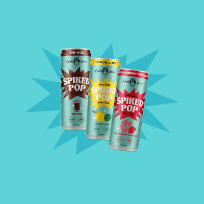Three cans of 'Spiked Pop' on a blue background